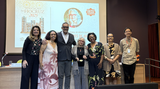 Foto dos participantes da mesa de abertura do evento, com a premiada: a coordenadora-geral de educação da Vice-Presidência de Educação, Informação e Comunicação, Isabella Delgado; a diretora da Asfoc, sindicato nacional da Fiocruz, Luciana Lindenmeyer; o presidente da Fiocruz, Mario Moreira; a homenageada, a professora Inesita Araújo; a vice-presidente de Educação, Informação e Comunicação da Fiocruz, Marly Cruz; a Coordenadora de Equidade, Diversidade, Inclusão e Políticas Afirmativas, Hilda Gomes; e o coo